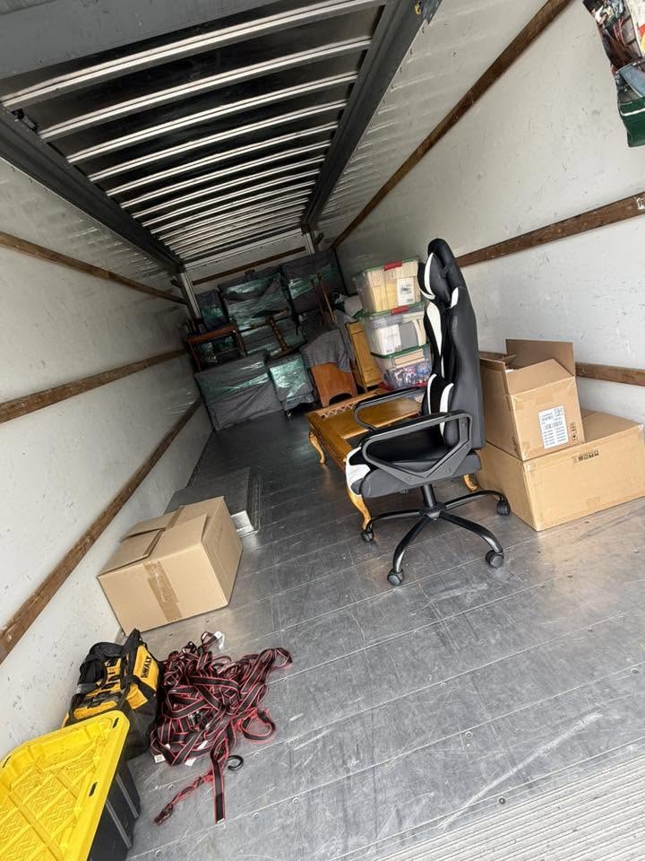 Office chair, boxes, and supplies staged in the back of the moving truck