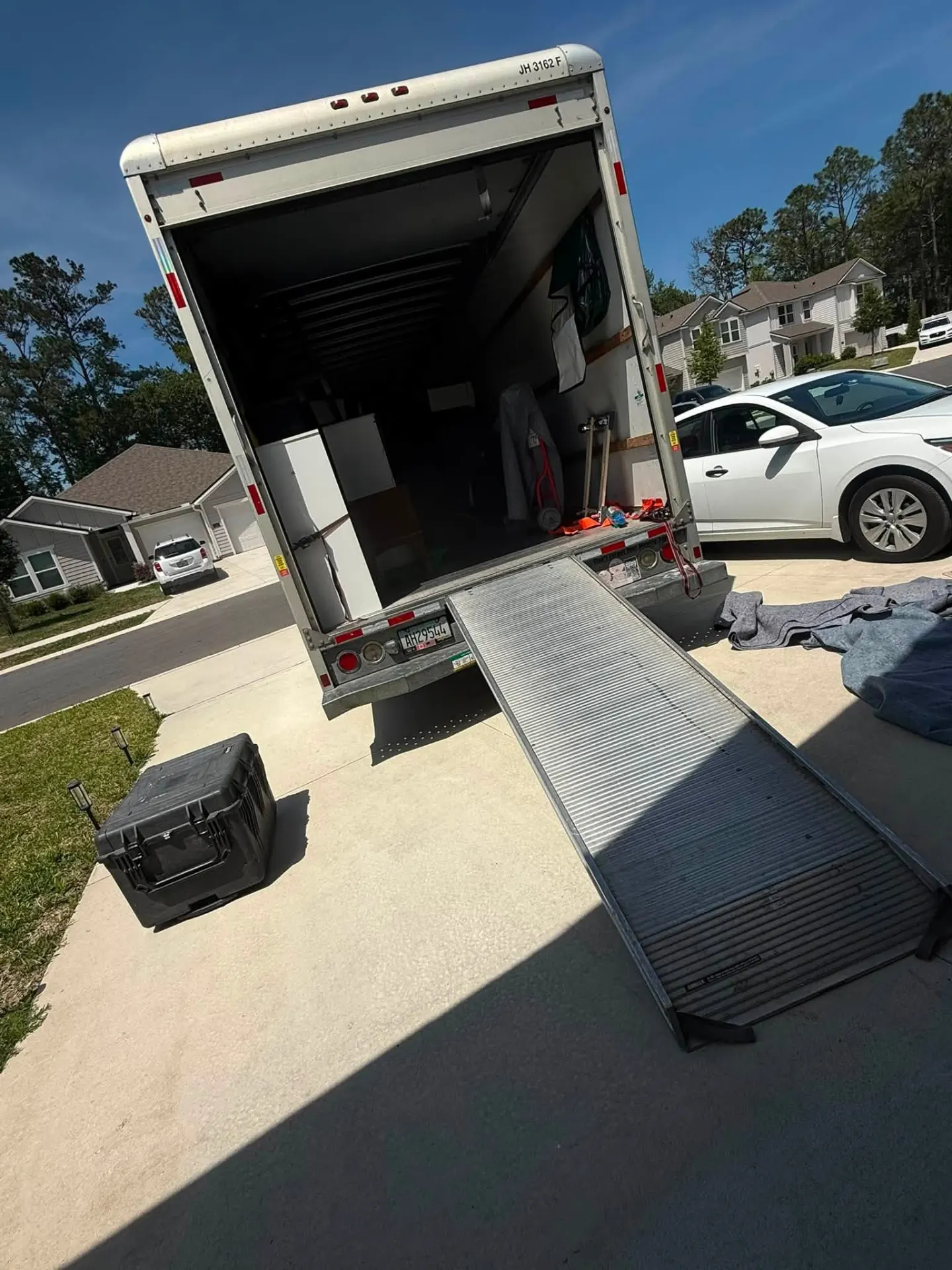 Box truck with ramp deployed at a Northeast Florida driveway